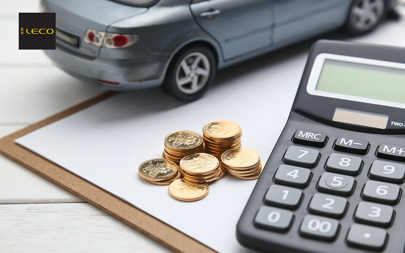 Calculator and coins used to calculate car down payment.