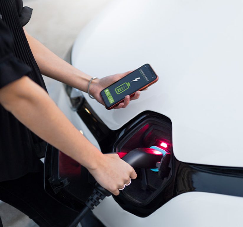 Charging an electric vehicle while monitoring costs on smartphone.
