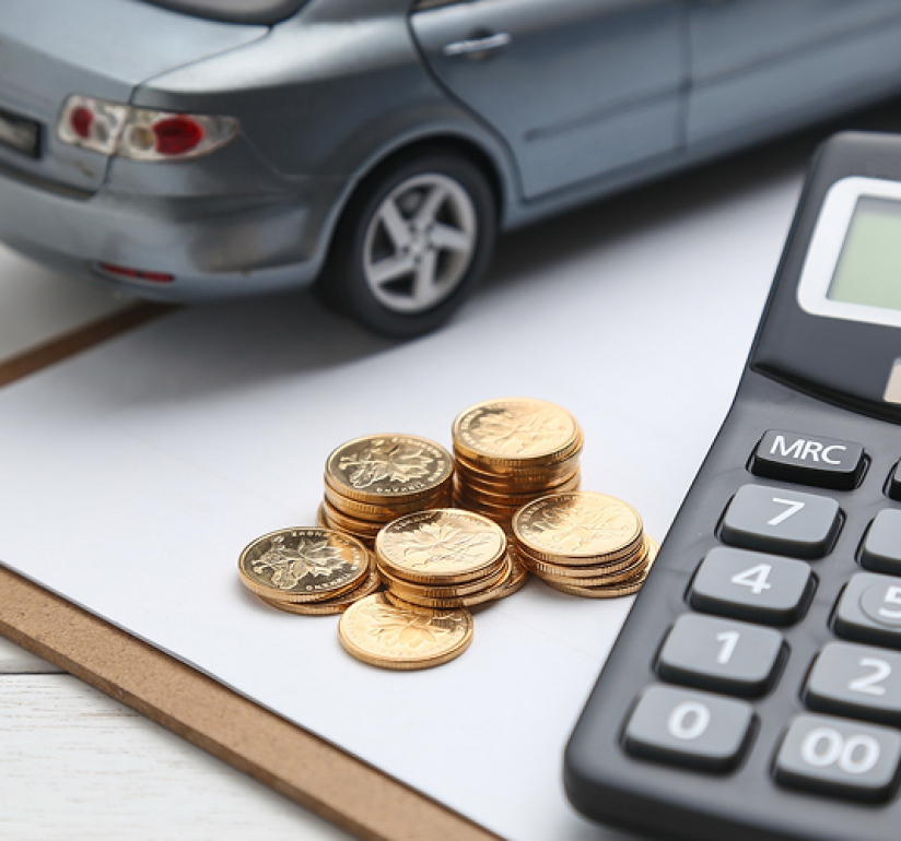 Calculator and coins used to calculate car down payment.